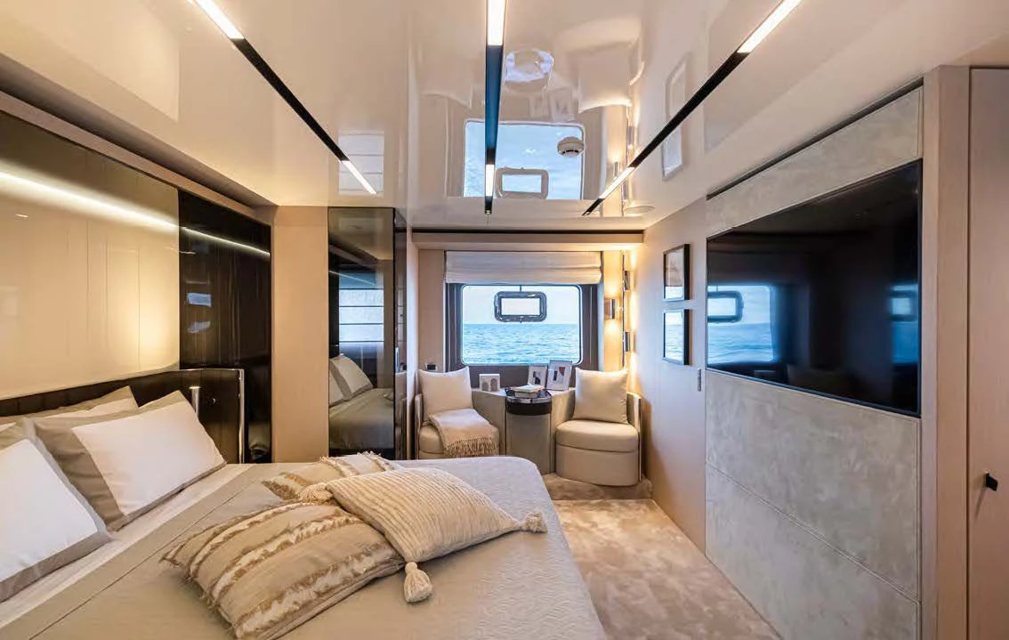 a room with a bed and a tv on the wall aboard SESSANTASETTE 67 Yacht for Sale