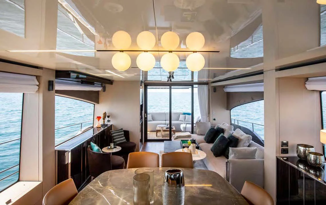 a living room with a large window aboard SESSANTASETTE 67 Yacht for Sale