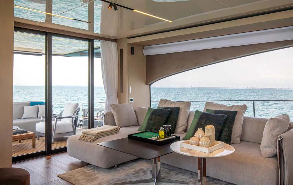 a living room with a large window aboard SESSANTASETTE 67 Yacht for Sale