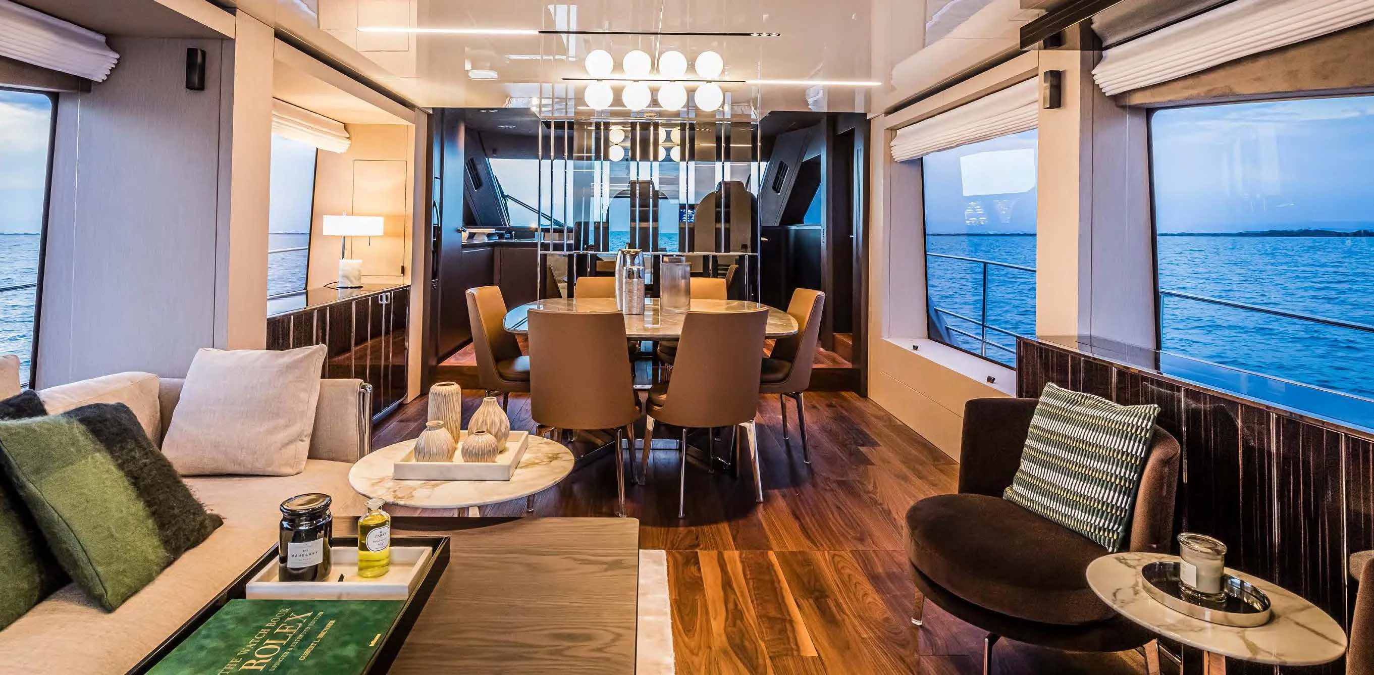 a room with a table chairs and a couch aboard SESSANTASETTE 67 Yacht for Sale