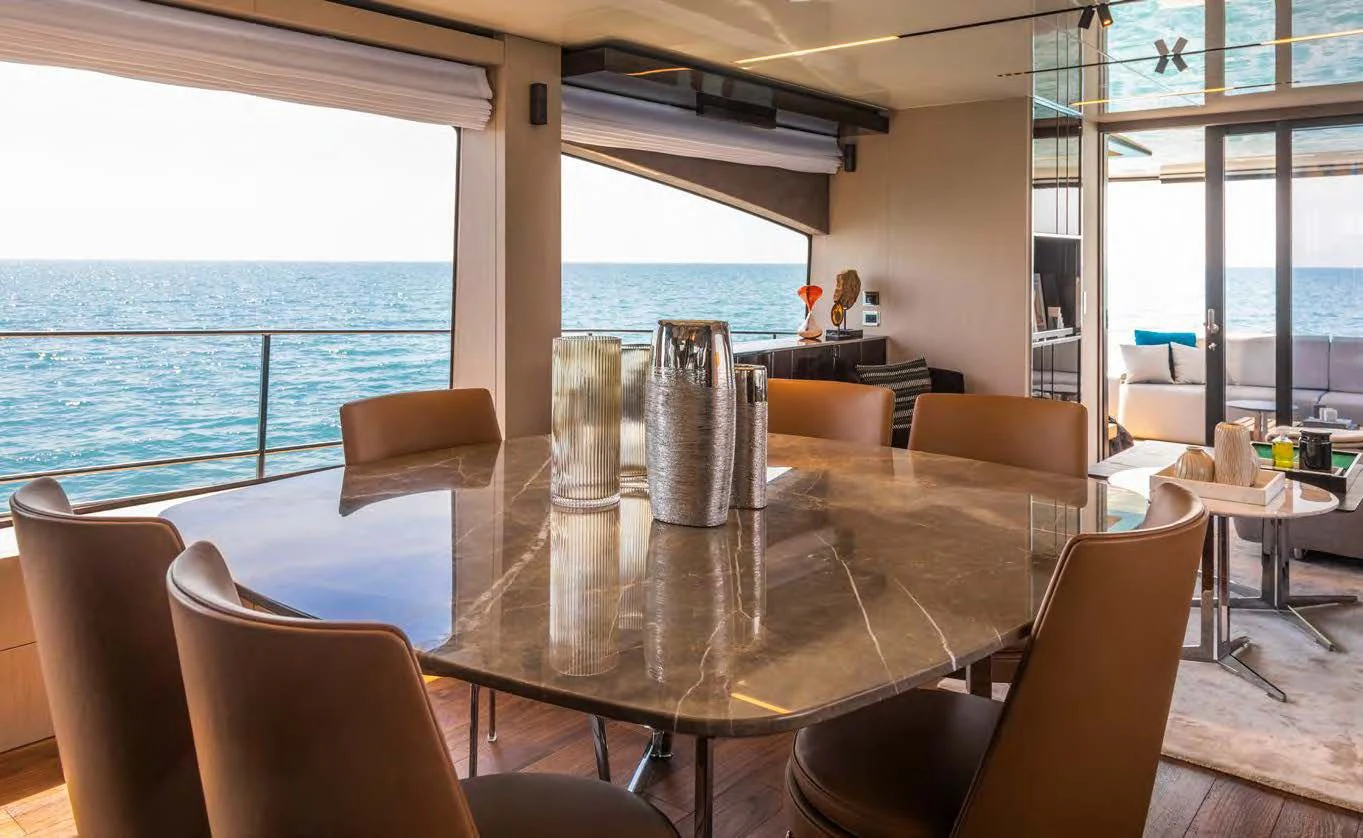 a room with a table and chairs aboard SESSANTASETTE 67 Yacht for Sale