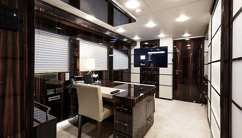 a room with a desk and chairs aboard GEMS 2 Yacht for Sale
