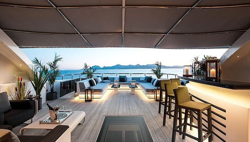 a room with a table chairs and a fireplace aboard GEMS 2 Yacht for Sale