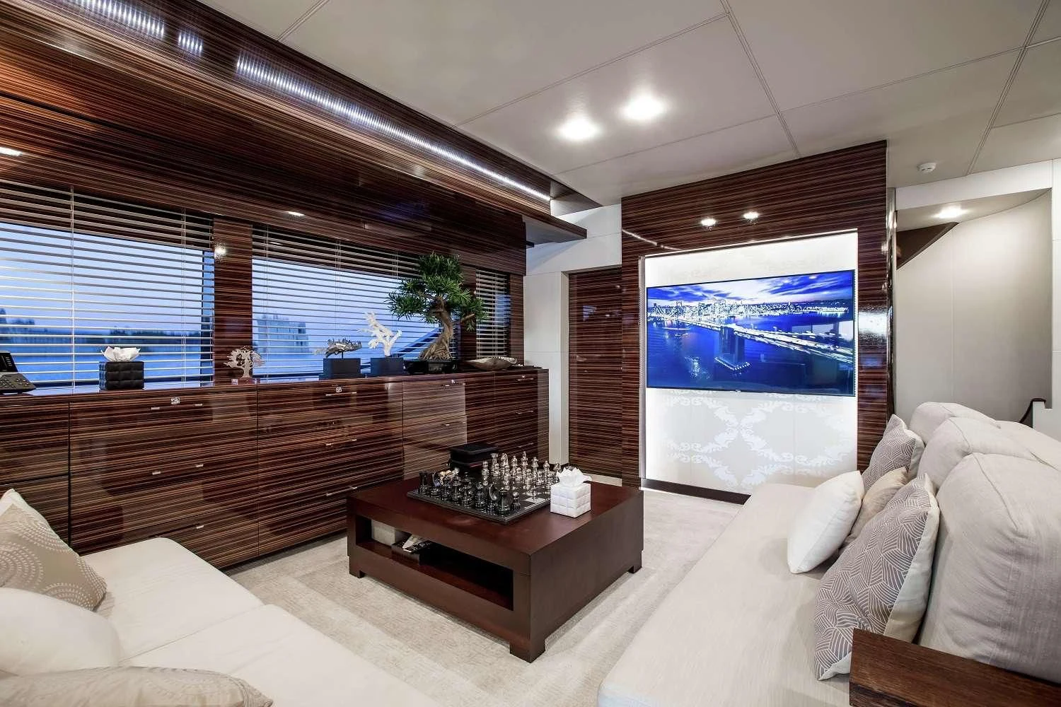 a living room with a large screen aboard GEMS 2 Yacht for Sale