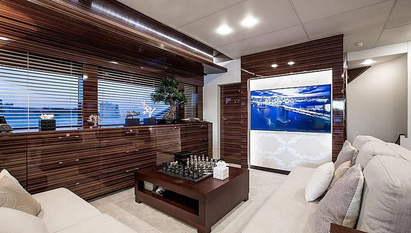 a living room with a large screen aboard GEMS 2 Yacht for Sale