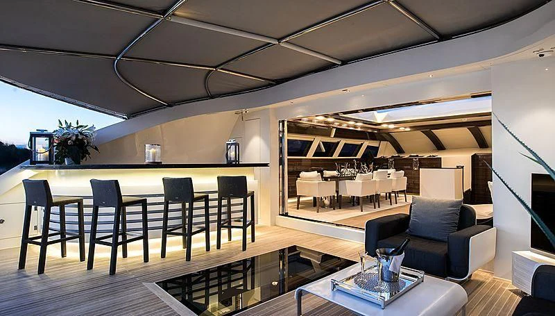 a room with a table chairs and a couch aboard GEMS 2 Yacht for Sale