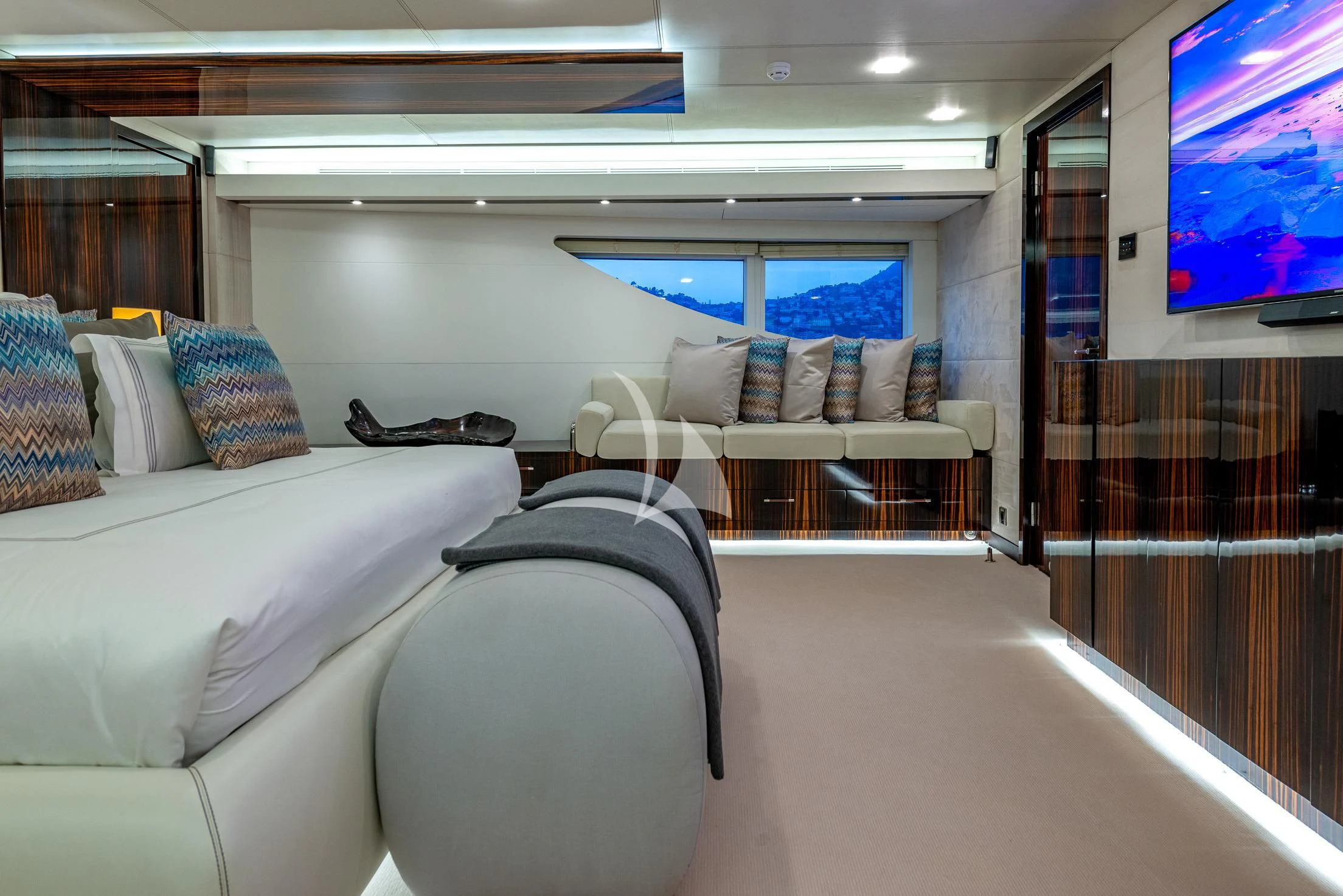 a room with a couch and a tv on the wall aboard GEMS 2 Yacht for Sale