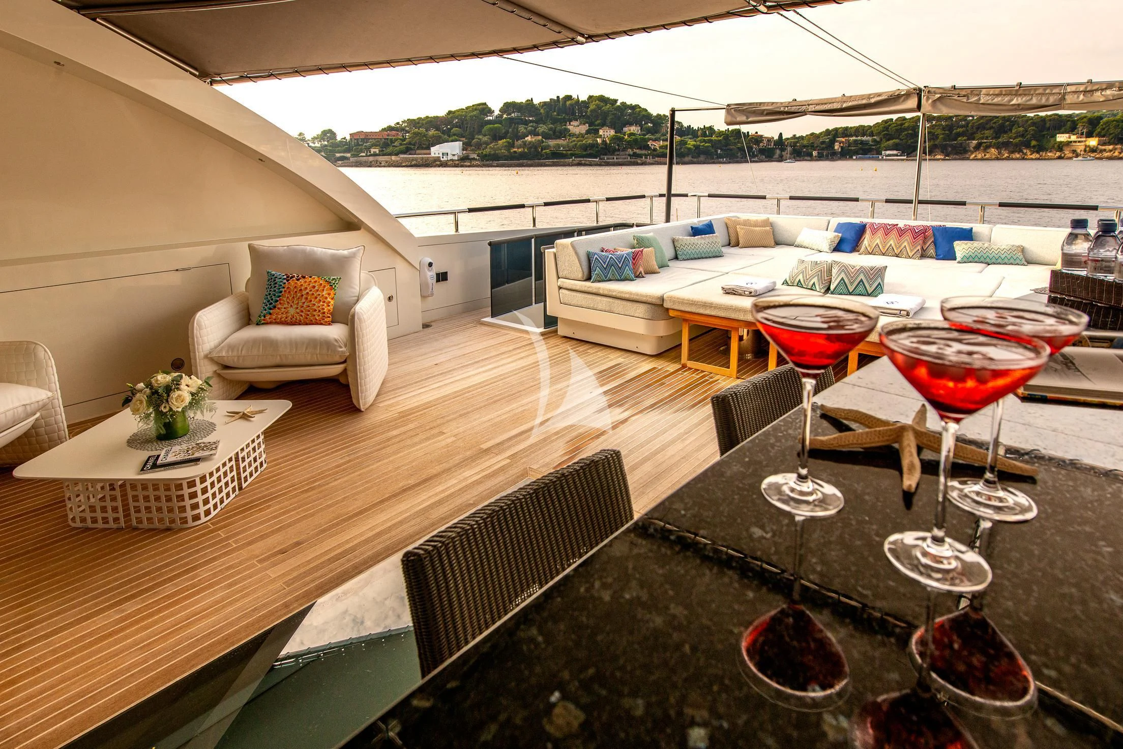 a patio with a table and chairs aboard GEMS 2 Yacht for Sale