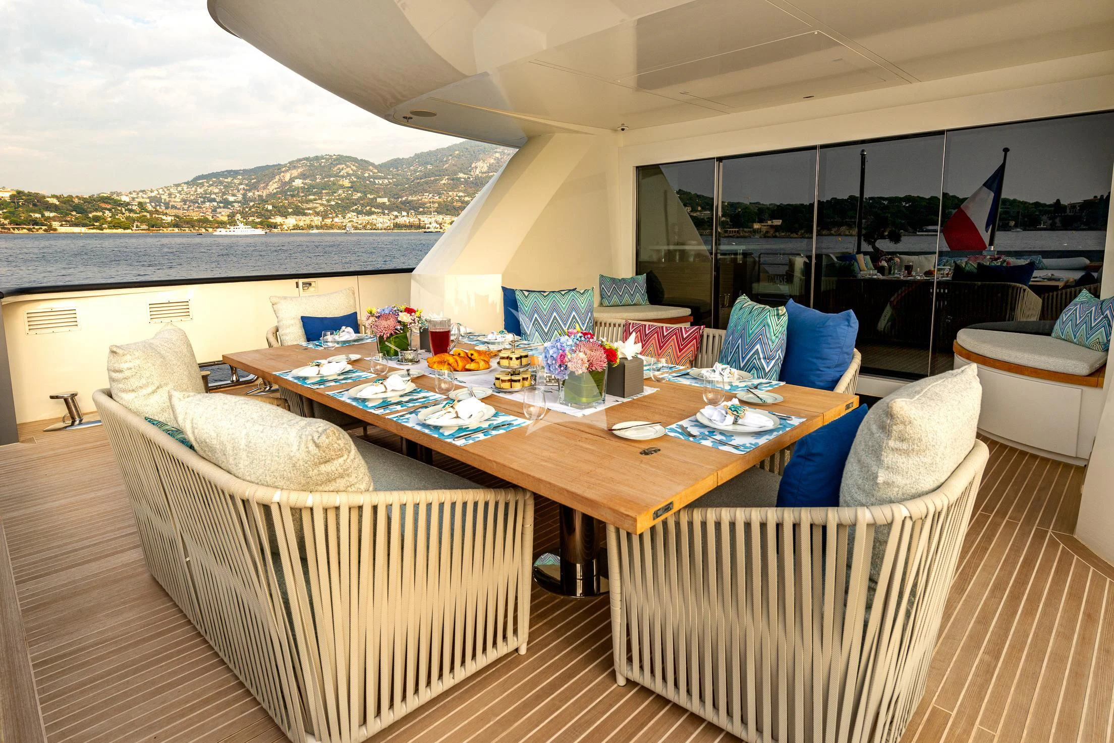 a table with chairs and a couch aboard GEMS 2 Yacht for Sale