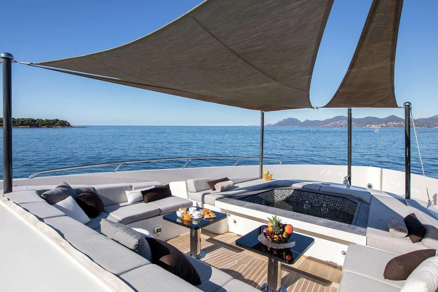 a large white lounge chair next to a large body of water aboard GEMS 2 Yacht for Sale