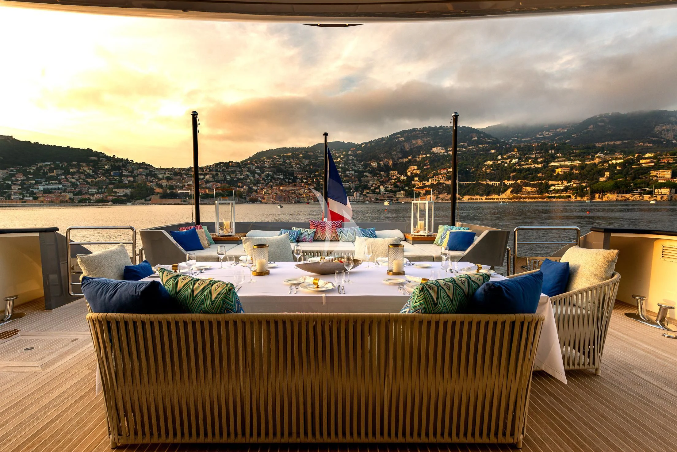 a deck with a table and chairs on it aboard GEMS 2 Yacht for Sale
