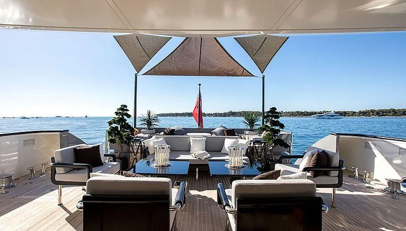 a table with chairs and umbrellas on it aboard GEMS 2 Yacht for Sale