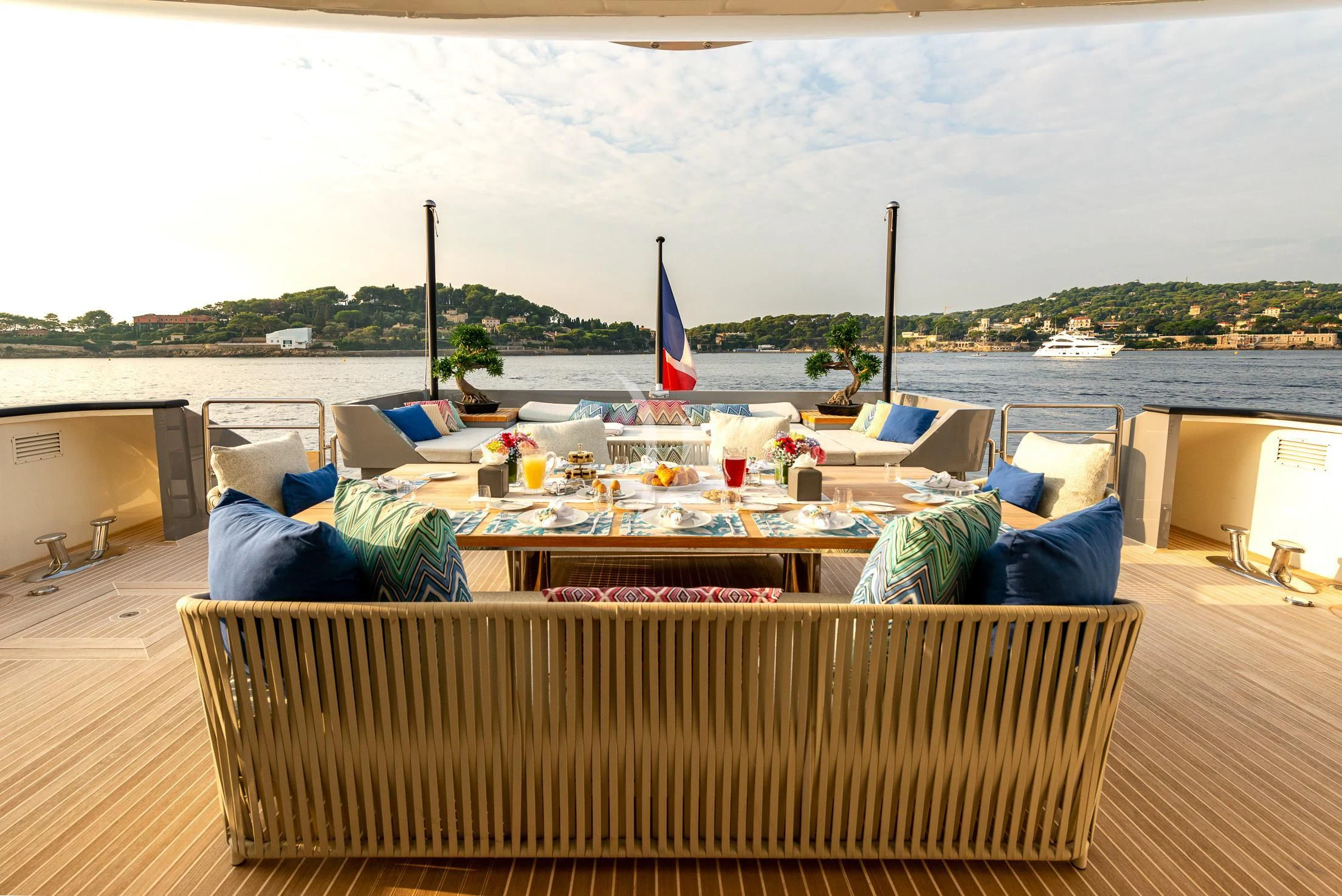a deck with a table and chairs on it aboard GEMS 2 Yacht for Sale