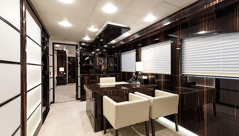 a room with a table and chairs aboard GEMS 2 Yacht for Sale