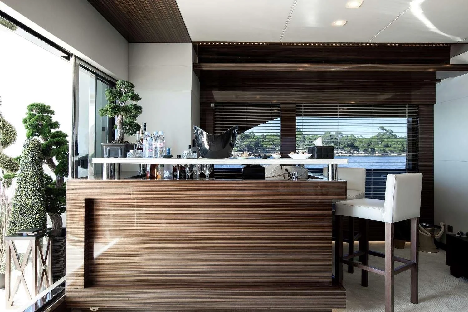 a room with a wood floor and a large window with a view of the city aboard GEMS 2 Yacht for Sale