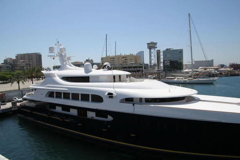 a large white boat in a harbor aboard TANUSHA Yacht for Sale