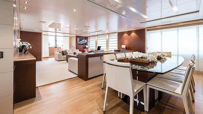 a large room with a table and chairs aboard ABVIOS Yacht for Sale