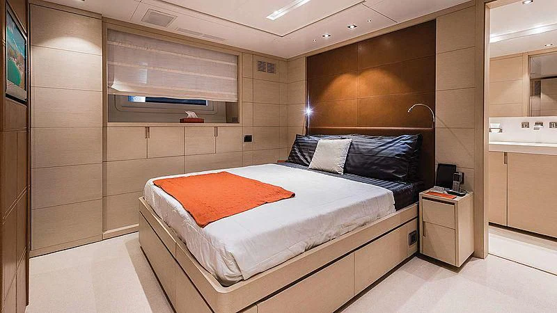 a bedroom with a bed and a desk aboard ABVIOS Yacht for Sale