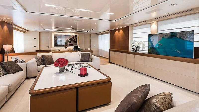 a living room with a table and couches aboard ABVIOS Yacht for Sale