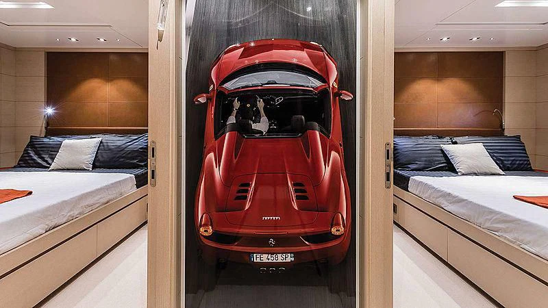 a red and black vehicle in a room with a bed and a white bed aboard ABVIOS Yacht for Sale