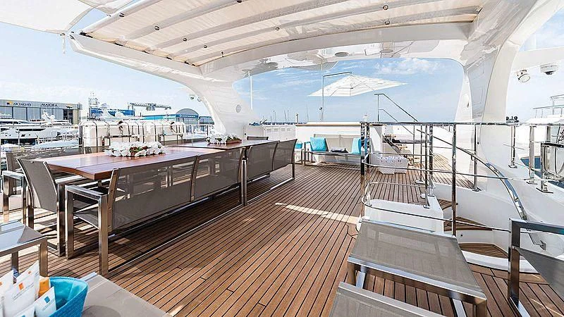 a large room with a bar and a table and chairs aboard ABVIOS Yacht for Sale