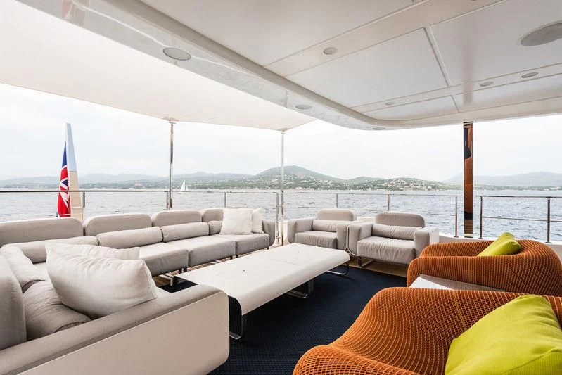 a large room with couches and a flag aboard ABVIOS Yacht for Sale