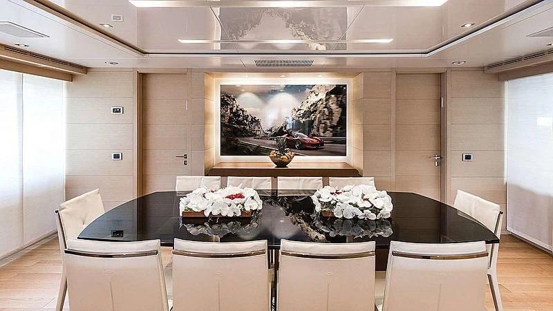a dining room table with a painting aboard ABVIOS Yacht for Sale