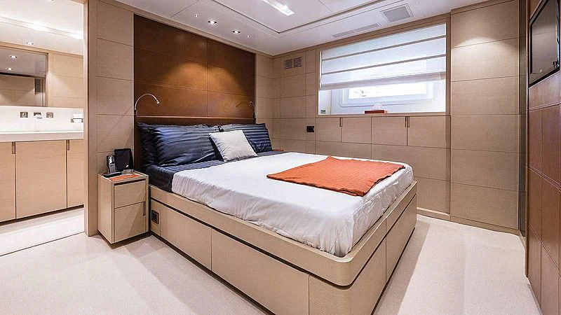 a room with a bed and a desk aboard ABVIOS Yacht for Sale