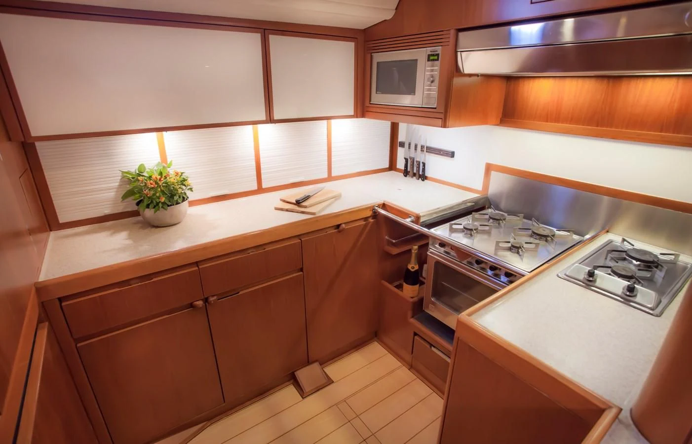 a kitchen with wooden cabinets aboard KIWI Yacht for Sale