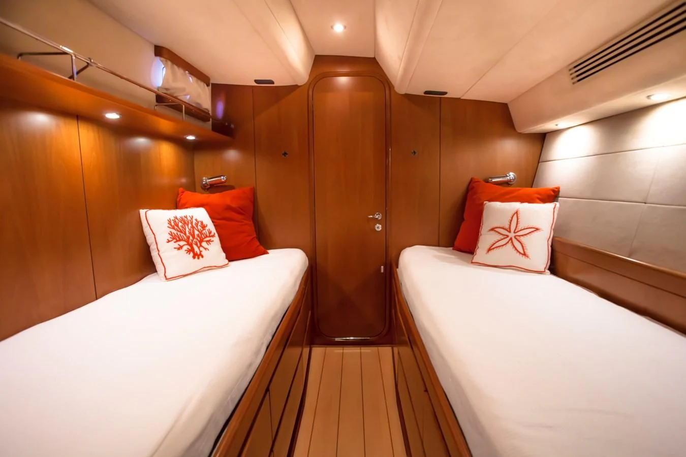 a room with beds and a closet aboard KIWI Yacht for Sale