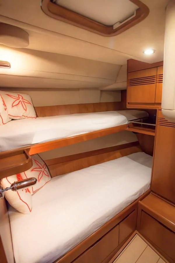a room with a bed and a lamp aboard KIWI Yacht for Sale