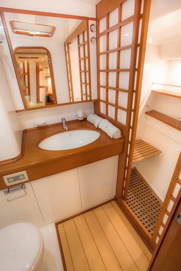 a bathroom with a sink and a mirror aboard KIWI Yacht for Sale