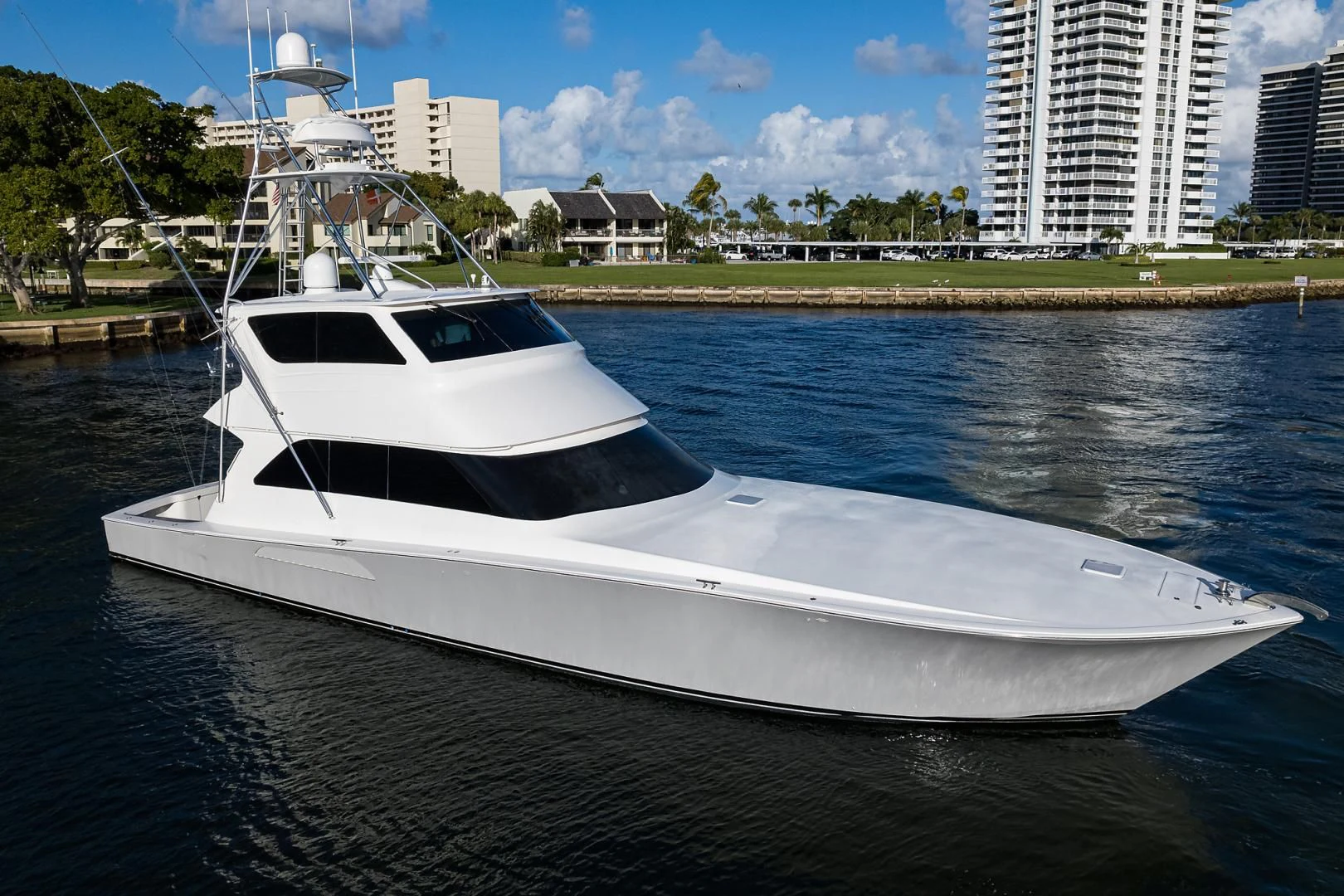 a white boat on a river aboard KNOT RACING Yacht for Sale
