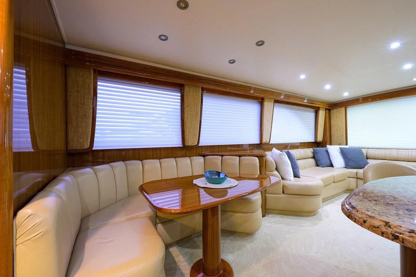 a living room with a table and couches aboard KNOT RACING Yacht for Sale