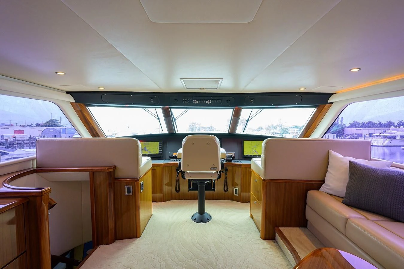 inside of a vehicle with a chair and a table and a bench aboard KNOT RACING Yacht for Sale