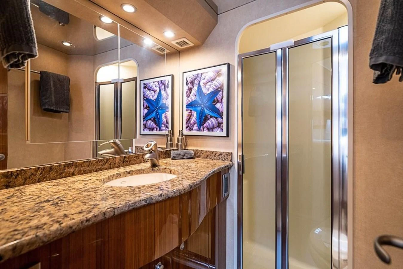 a bathroom with a countertop sink and a mirror aboard KNOT RACING Yacht for Sale