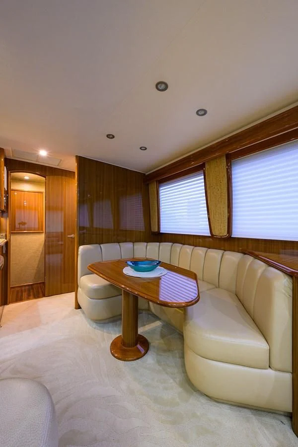 a living room with a table and chairs aboard KNOT RACING Yacht for Sale