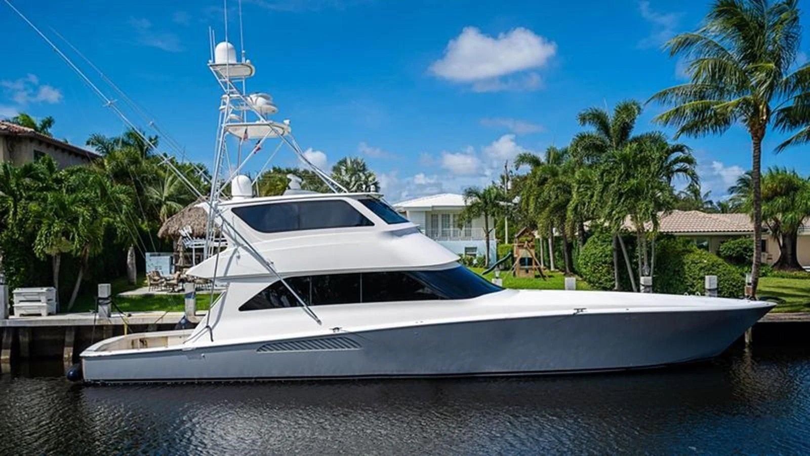 a white yacht docked at a dock aboard KNOT RACING Yacht for Sale