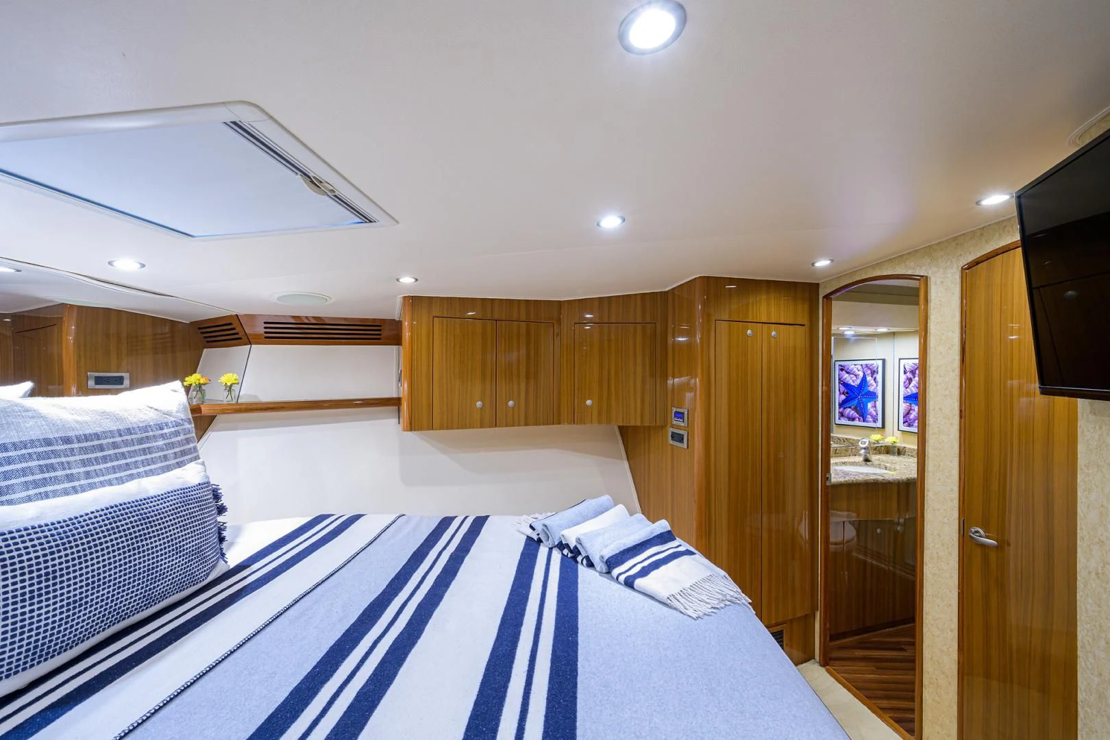 a room with a bed and a wood door aboard KNOT RACING Yacht for Sale