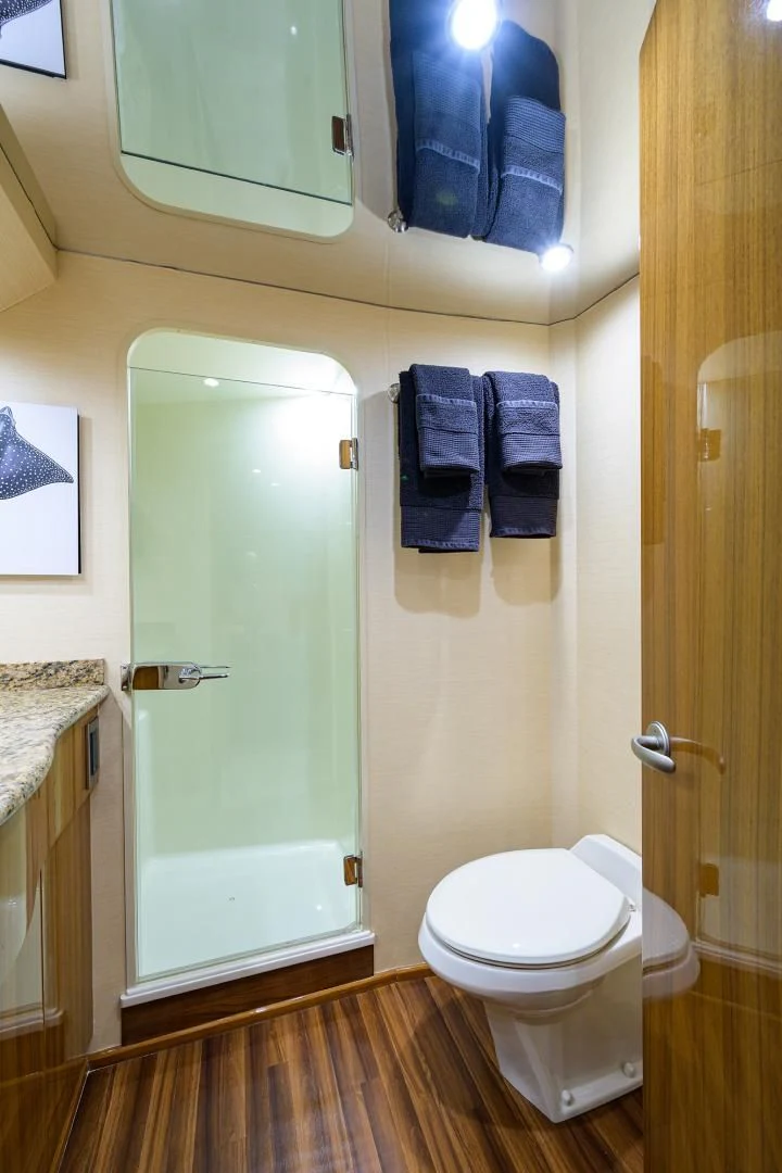 a bathroom with a toilet and a shower aboard KNOT RACING Yacht for Sale