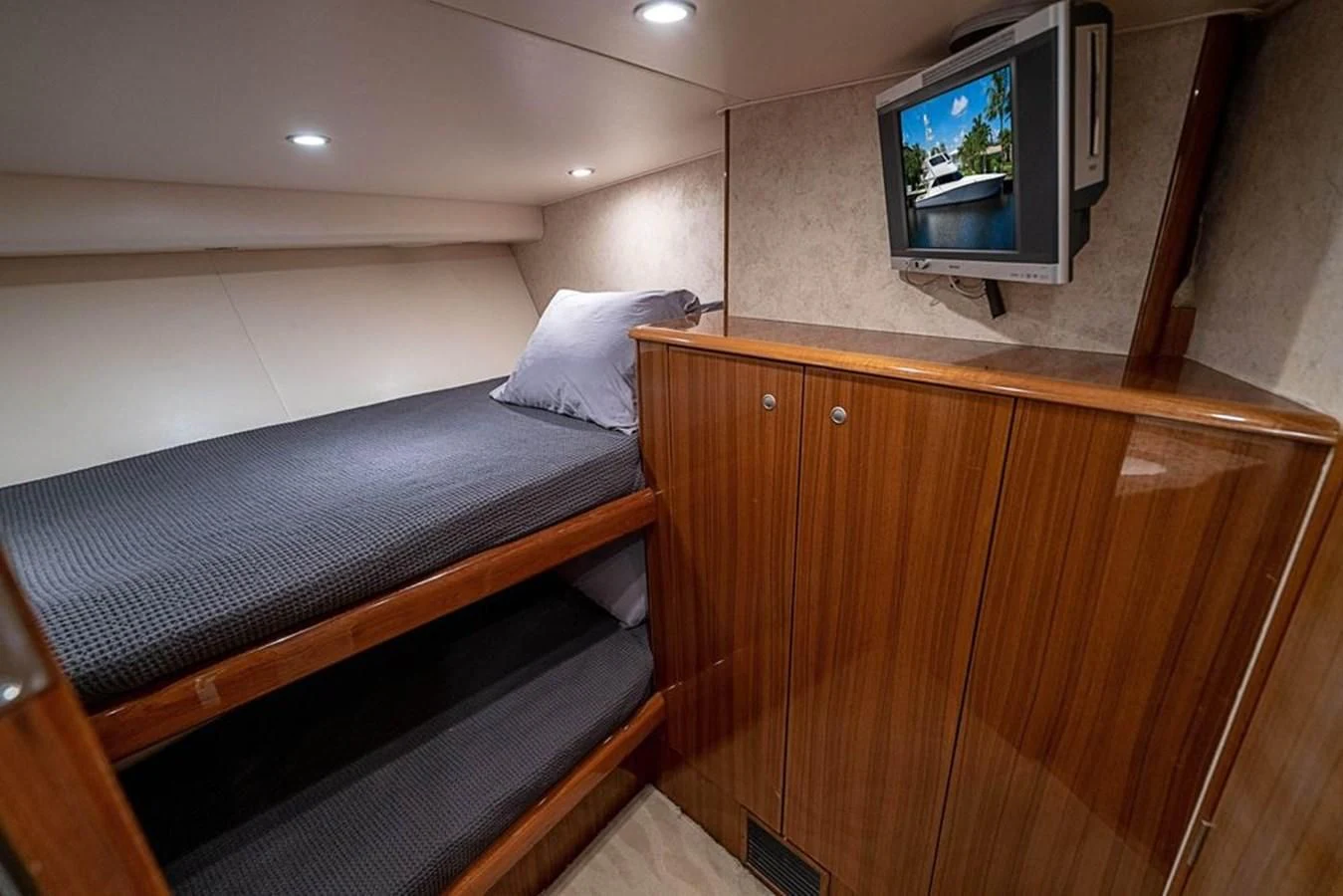 a bed with a television on the wall aboard KNOT RACING Yacht for Sale