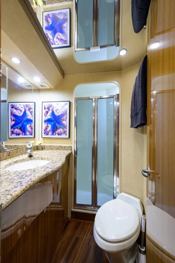 a bathroom with a toilet and a sink aboard KNOT RACING Yacht for Sale