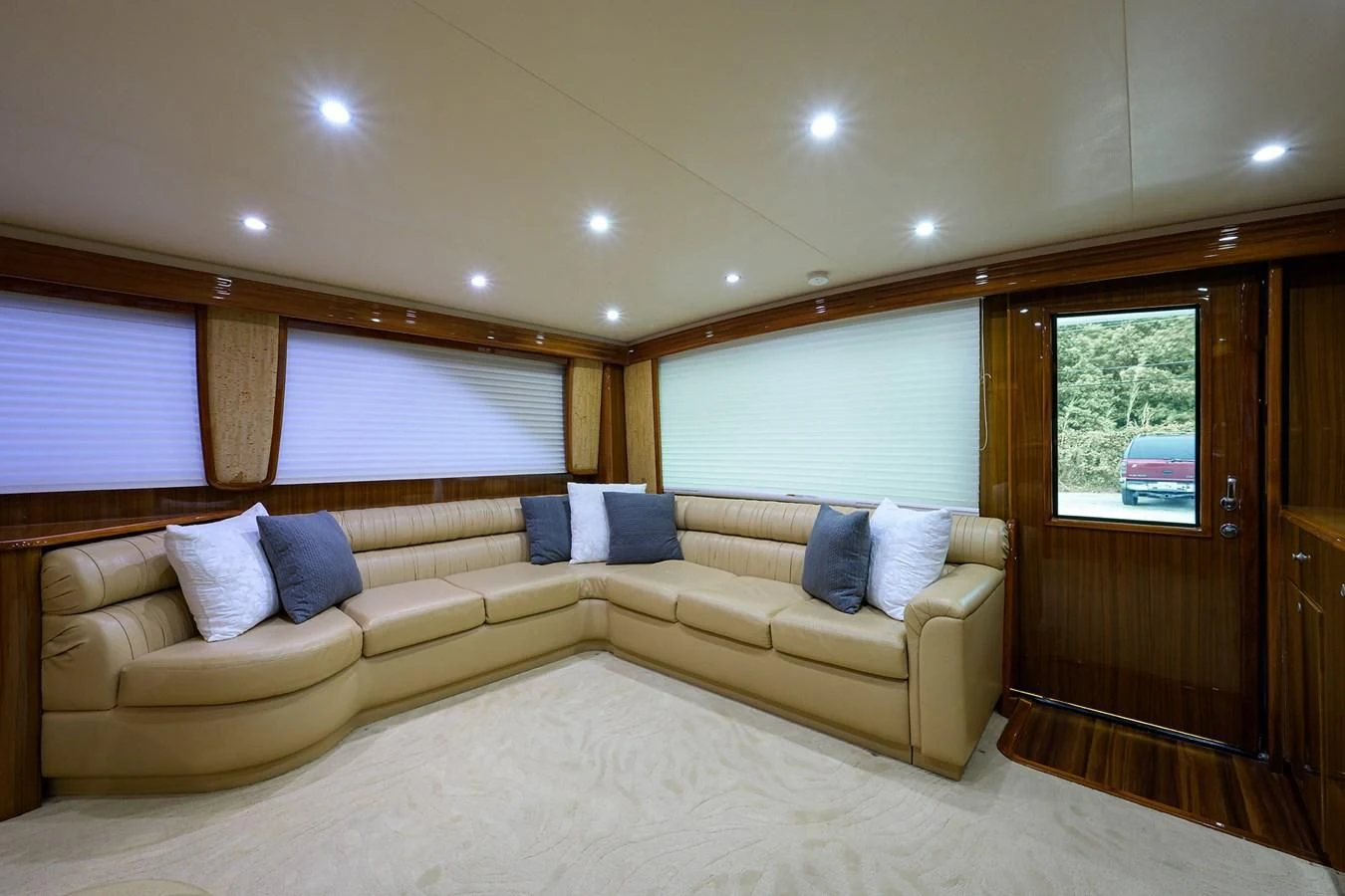 a living room with a couch and a wood cabinet aboard KNOT RACING Yacht for Sale