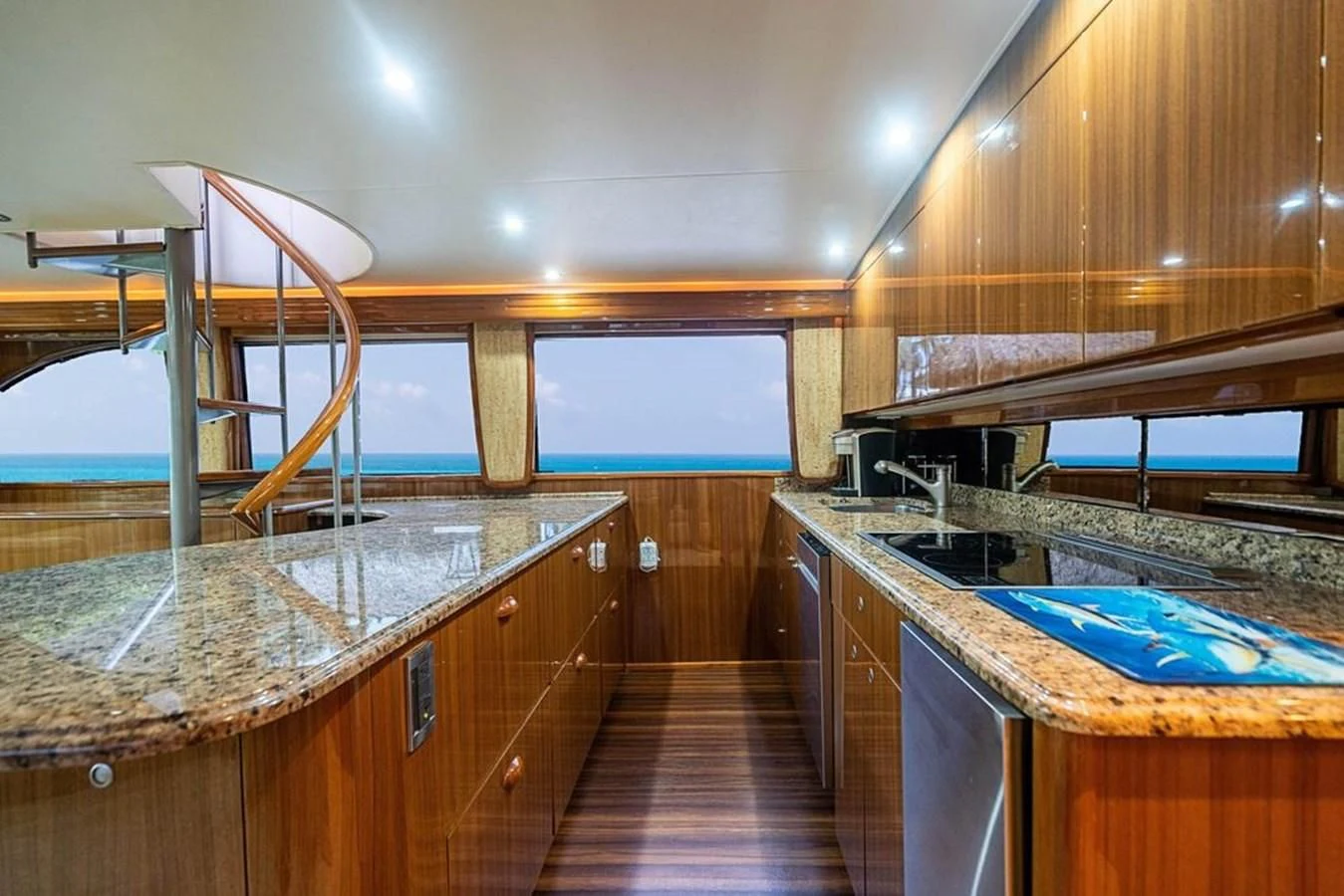 a kitchen with wooden cabinets aboard KNOT RACING Yacht for Sale
