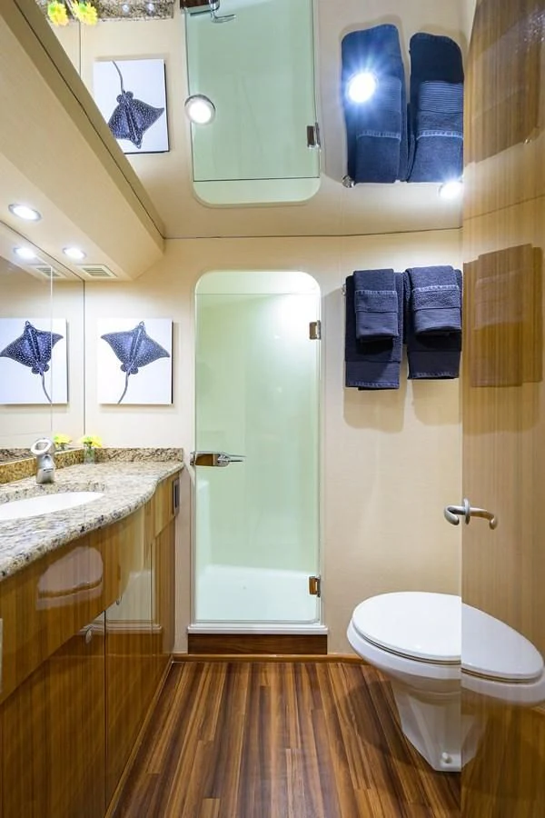 a bathroom with a toilet and a sink aboard KNOT RACING Yacht for Sale