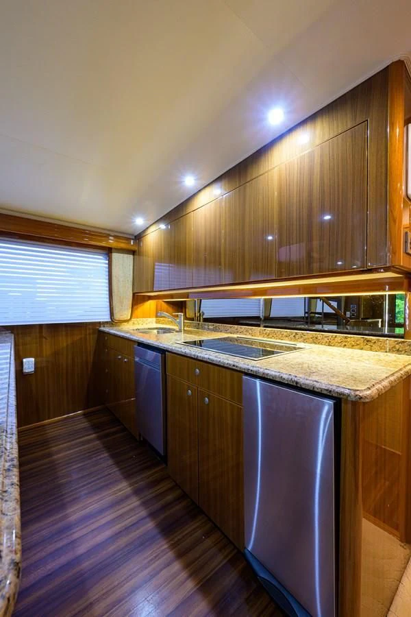 a kitchen with wooden cabinets aboard KNOT RACING Yacht for Sale