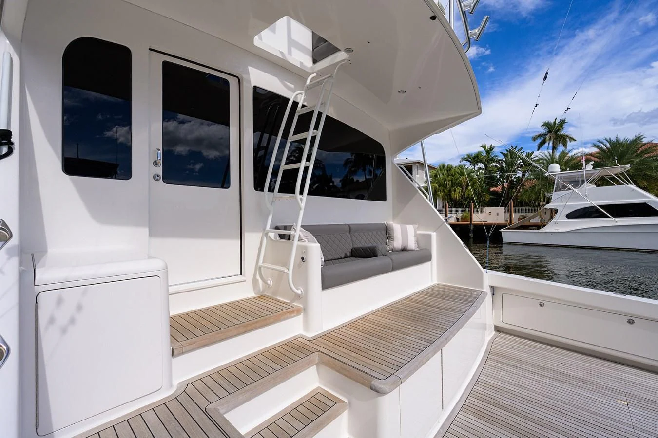 a white house with a deck and a pool aboard KNOT RACING Yacht for Sale