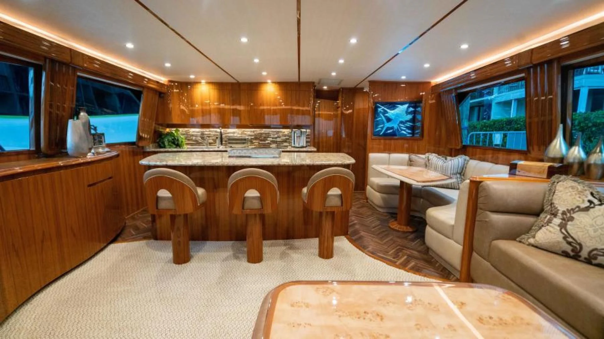 a large living room with a table and couches aboard NEVER TOO LATE Yacht for Charter