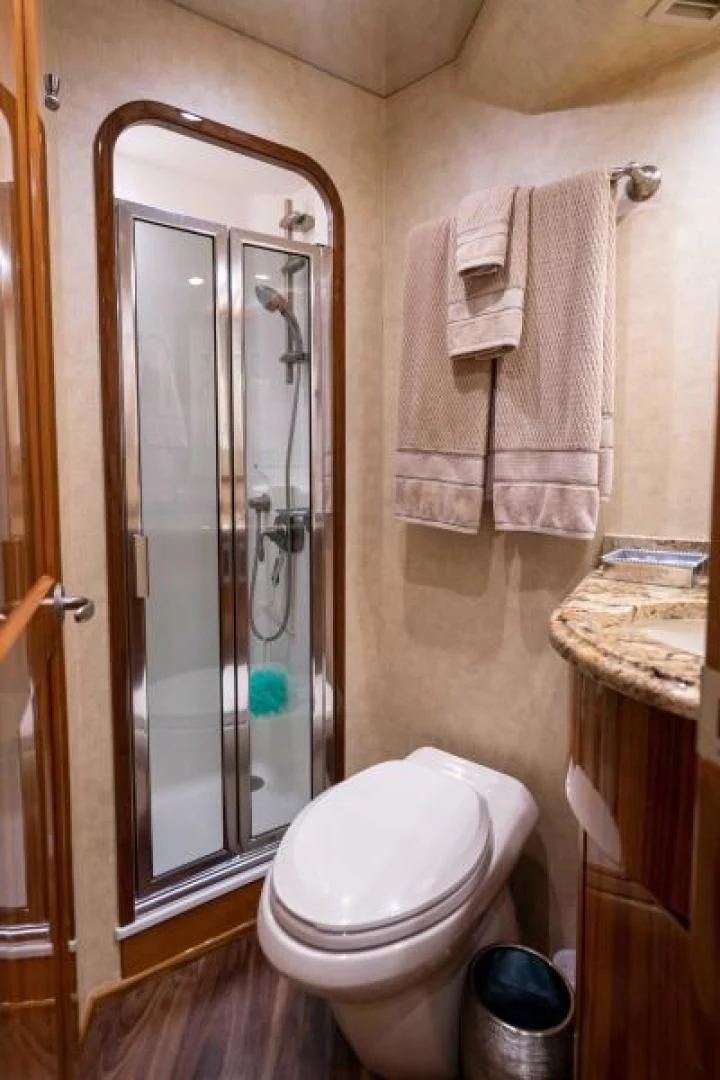 a bathroom with a glass shower door aboard NEVER TOO LATE Yacht for Charter