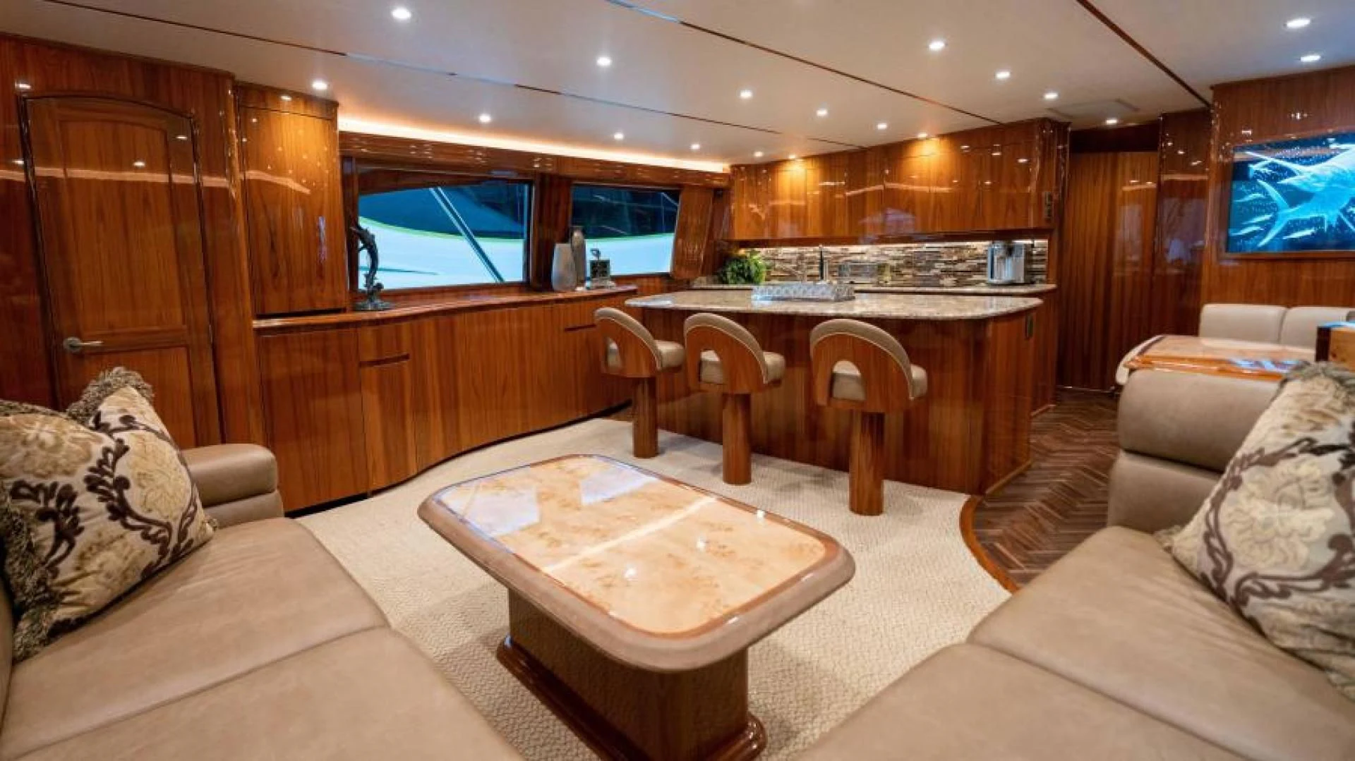a living room with a kitchen and dining area aboard NEVER TOO LATE Yacht for Charter